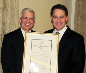 NCMS Foundation Director of Rural Health Initiatives Franklin Walker (left) with NCMS EVP/CEO Robert W. Seligson (right), holding the award from the Governor,